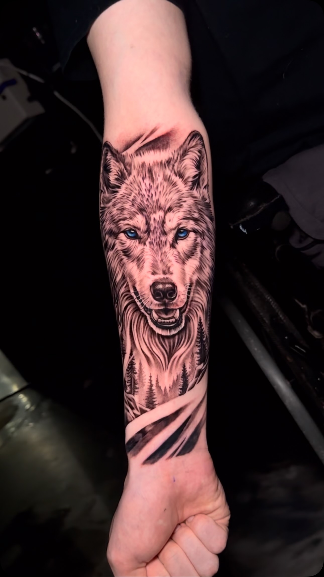Black and gray wolf realism tattoo with colored eyes by Pablo