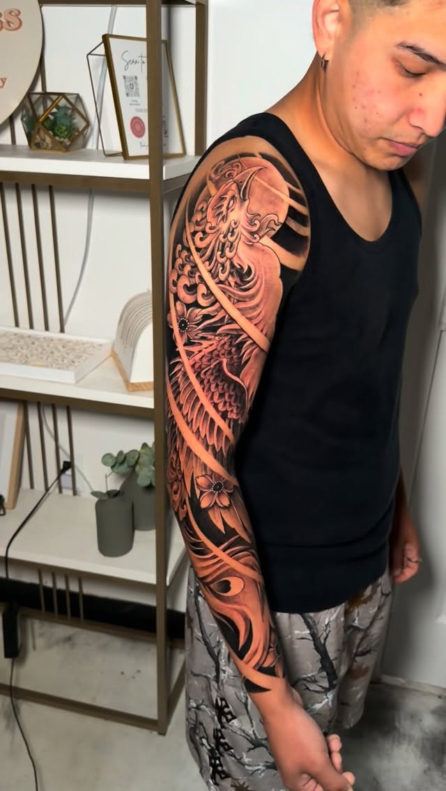 Large phoenix sleeve tattoo created at Timeless Ink Studio